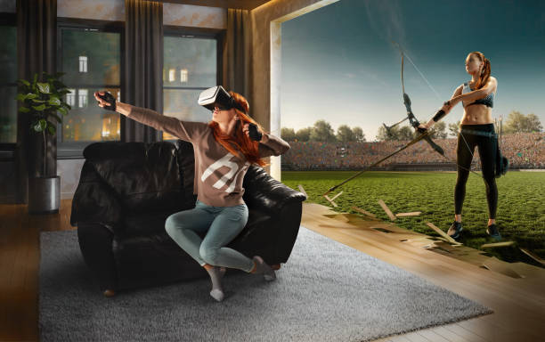 Woman in VR Glasses. Virtual Reality with Archery Beautiful woman at home on a black sofa with VR headset shoots with the longbow in virtual reality virtual reality point of view photos stock pictures, royalty-free photos & images