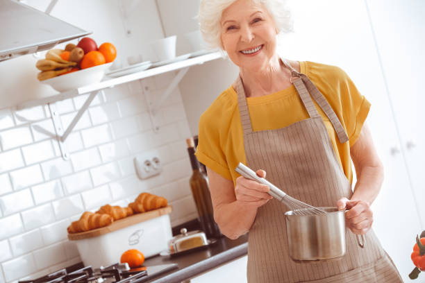 istock Handsome happiness housewife whisks eggs on a sponge cake 1145727719