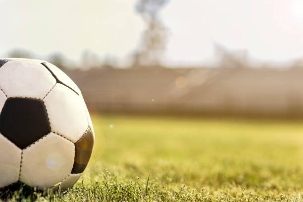 istock Soccer ball on stadium field at school campus. 1145729078