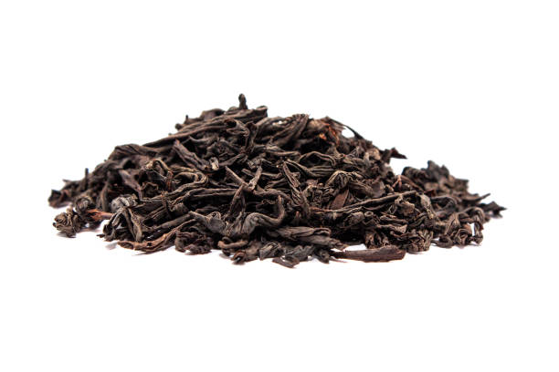 istock Black dry tea leaves isolated on white background. Side view 1145729990