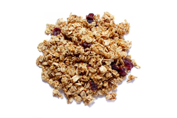 istock Crunchy granola or muesli scattered, isolated on white, top view. 1145731428