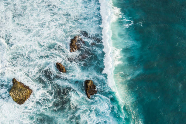 istock Aerial view of crashing waves on rocks 1145738000