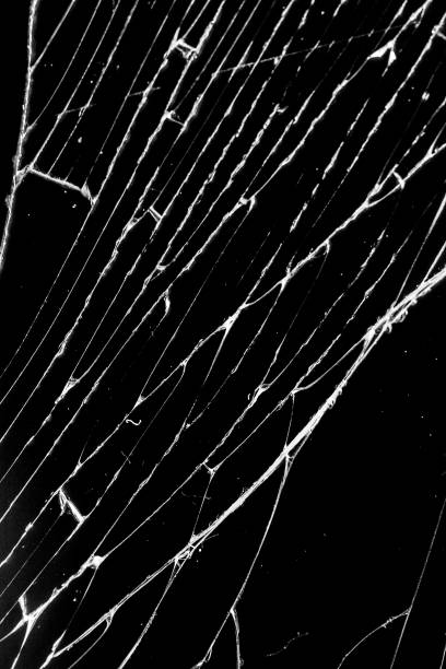 istock cracked glass isolated on a black background. broken glass 1145740698