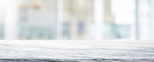 istock Empty white marble stone table top on blurred with bokeh shopping mall and restaurent interior banner background - can be used for display or montage your products 1145742666