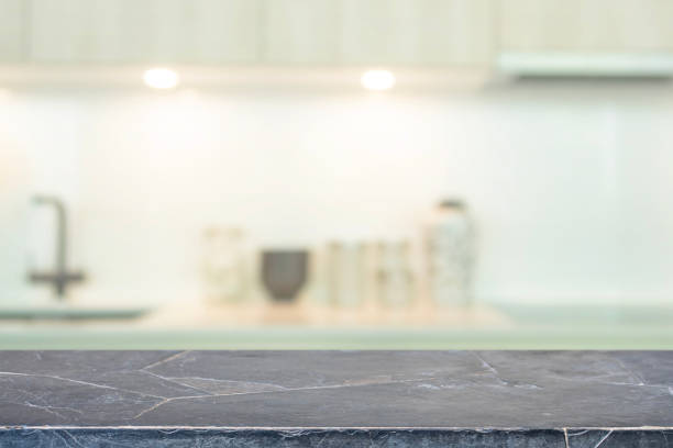 istock Empty black marble stone table top and blurred kitchen interior background with vintage filter - can used for display or montage your products. 1145742676