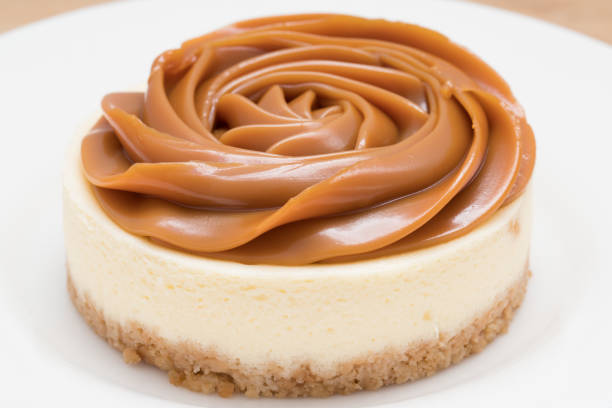 Homemade Sweet Milk (milk-based caramel/Doce de Leite) cheesecake. Homemade dulce de leche (milk-based caramel/ doce de leite) cheesecake. dulce de leche stock pictures, royalty-free photos & images