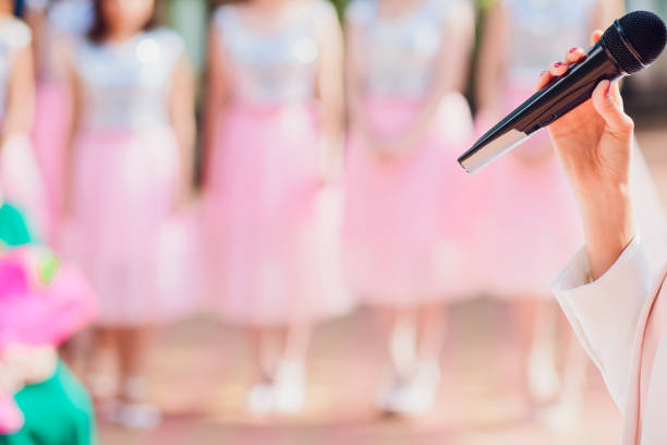 istock Master ceremony speech on microphone background wedding couple. microphone on the background of bridesmaids 1145746092