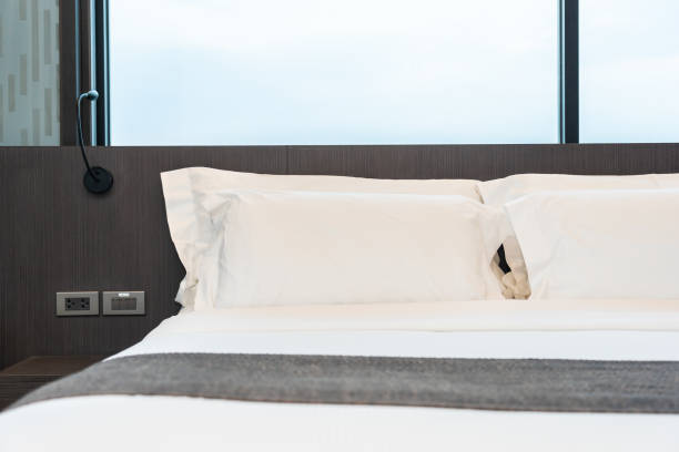istock Beautiful luxury comfortable white pillow and blanket on bed with light lamp 1145749527