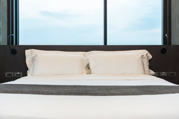 istock Beautiful luxury comfortable white pillow and blanket on bed with light lamp 1145749676