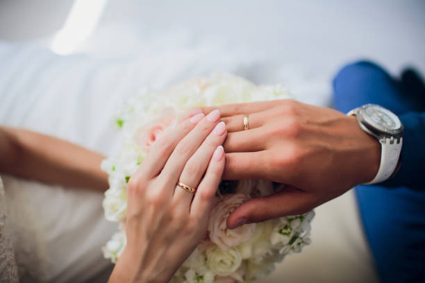 istock Groom and brides hands with rings, closeup view. 1145749773