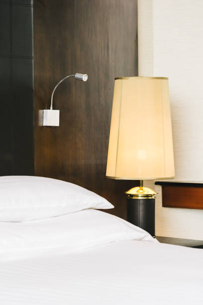 istock Beautiful luxury comfortable white pillow and blanket on bed with light lamp 1145750417
