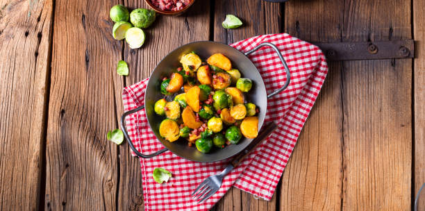 istock Brussels sprouts potato pan with bacon in rustic style 1145754332