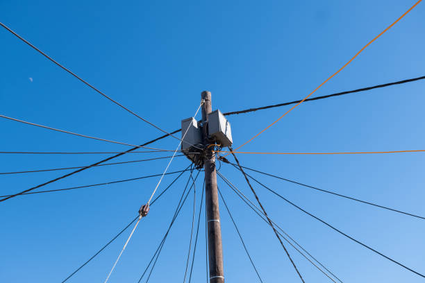 Many power cables connecting to a single pole in Kayamandi Township, Cape Town