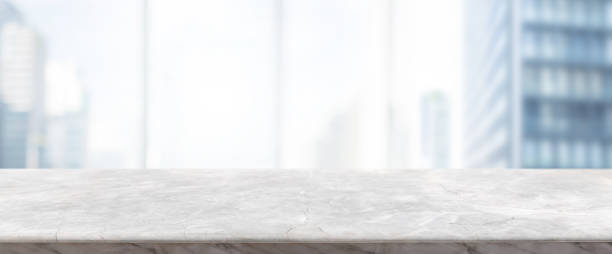 istock Empty white marble stone table top and blur glass window wall building banner mock up background - can used for display or montage your products. 1145756880