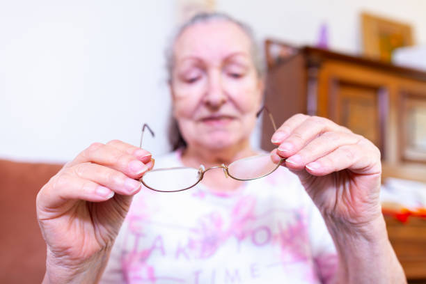 istock An old woman puts on her glasses 1145764139