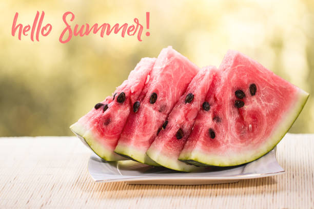 HELLO SUMMER greeting card. sliced watermelon on wooden table. oncept of summertime and vacations.