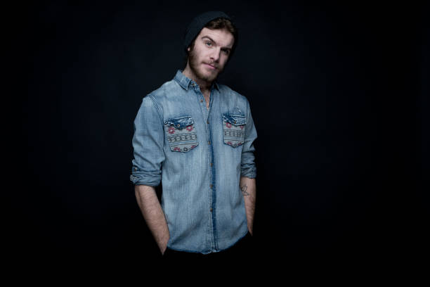 istock Cool hip man standing in front of black background 1145765412