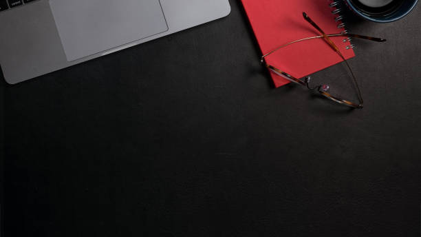 istock Top view office dark top table workspace with office supplies and copy space 1145765560