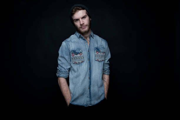 istock Cool hip man standing in front of black background 1145766218