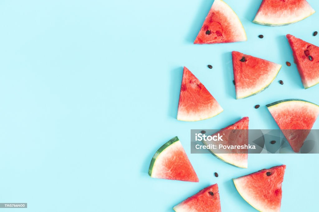 Watermelon pattern. Red watermelon on blue background. Summer concept. Flat lay, top view, copy space Summer Stock Photo