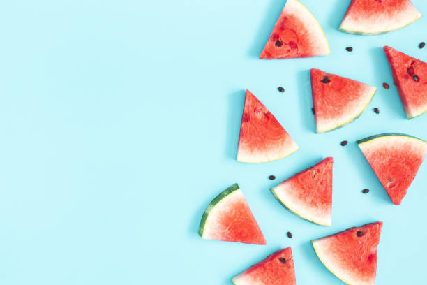 Watermelon pattern. Red watermelon on blue background. Summer concept. Flat lay, top view, copy space Watermelon pattern. Red watermelon on blue background. Summer concept. Flat lay, top view, copy space watermelon stock pictures, royalty-free photos & images