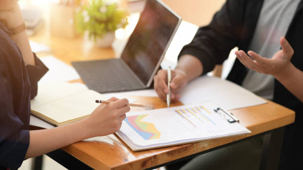 istock Businesspeople using digital tablet and paper work in office together 1145766538