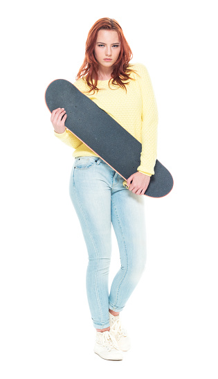 Cute female holding a skateboard