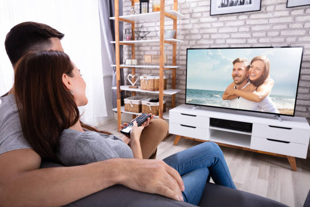istock Couple Watching Television At Home 1145767005