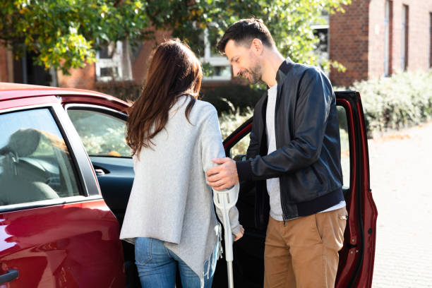 istock Husband Helping Her Disabled Wife To Get Inside The Car 1145767075