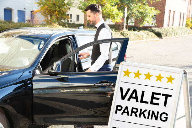 istock Happy Male Valet Opening Car Door 1145767314