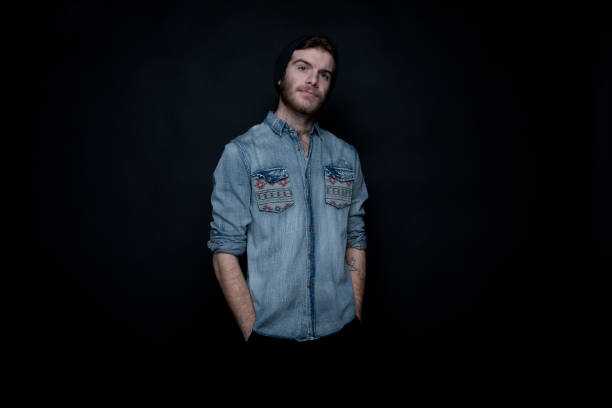 istock Cool hip man standing in front of black background 1145767337