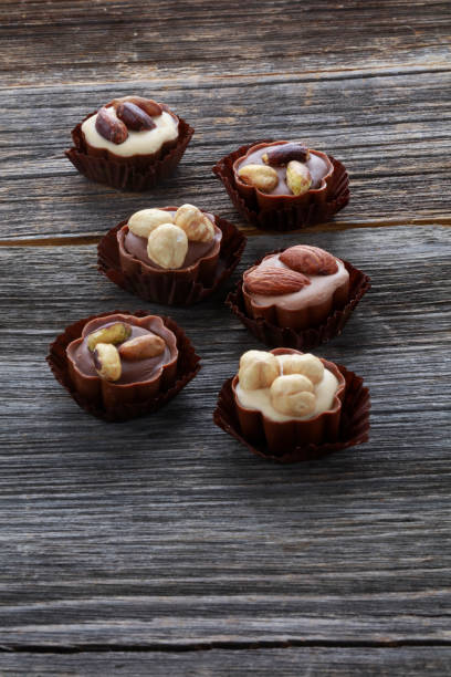 istock chocolate nuts on old wood background 1145768422