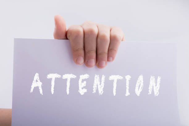 istock Hand holding paper with attention wording 1145769004