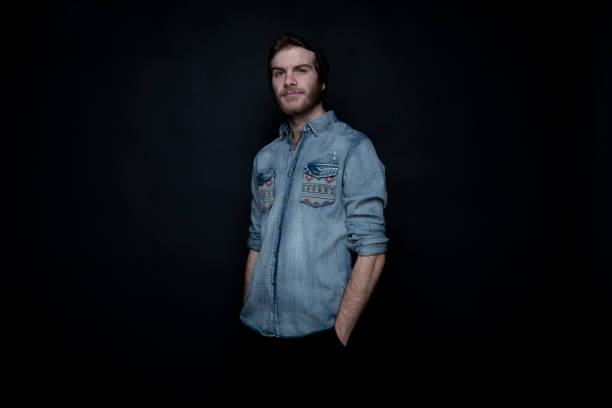 istock Cool hip man standing in front of black background 1145769272
