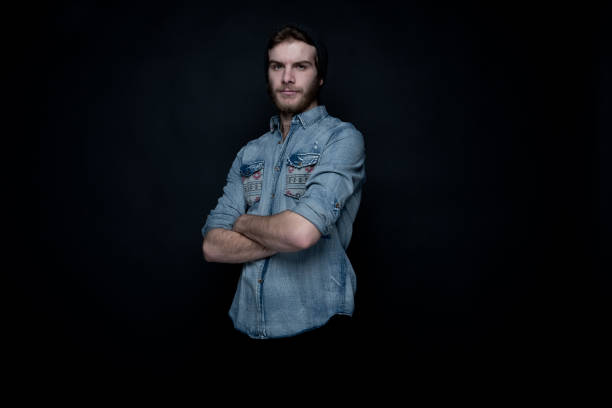 istock Cool hip man standing in front of black background 1145769273