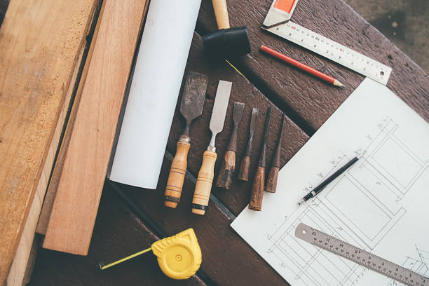 istock Equipment on wooden desk with man working in workshop background. 1145769636