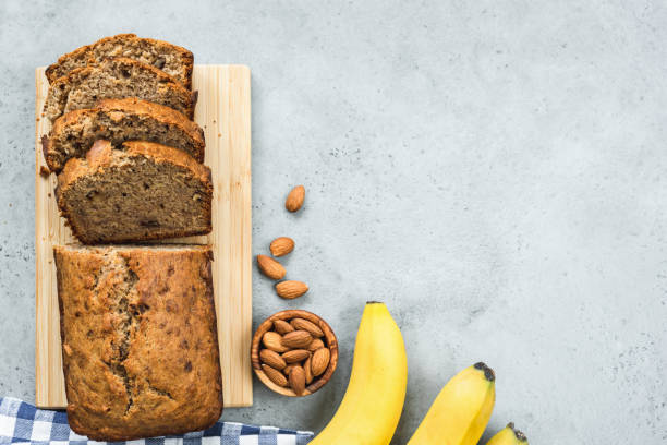 Healthy banana bread loaf on concrete background top view Healthy paleo banana bread loaf on grey concrete background. Table top view pound cake stock pictures, royalty-free photos & images