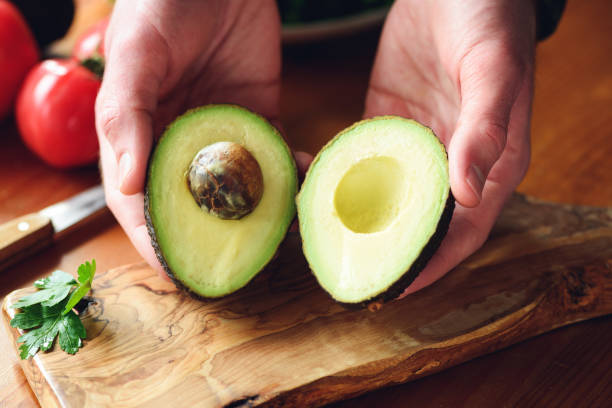 istock Tasty avocado in hands 1145769972