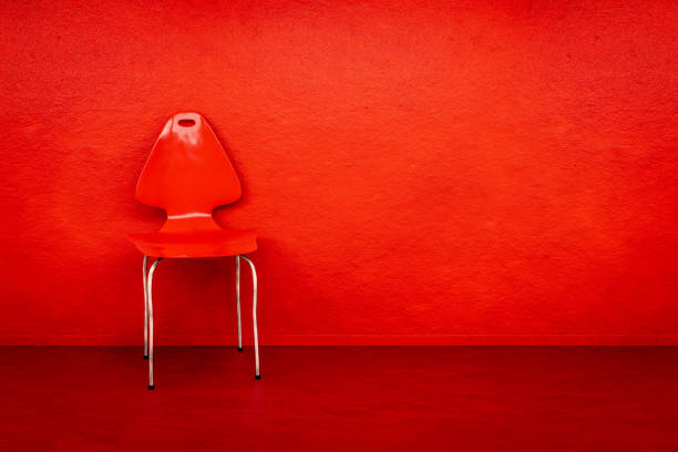 A red chair at a red wall with space for your content 3d illustration