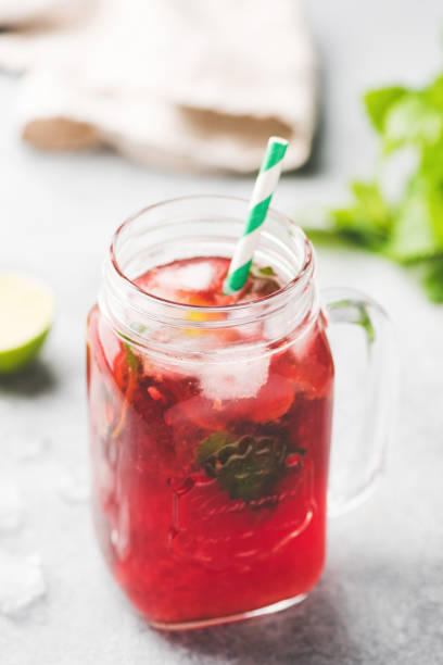 Berry Ice Tea In Glass Cup Berry Ice Tea In Glass Cup With Drinking Straw. Selective Focus, Vertical Orientation red drink stock pictures, royalty-free photos & images