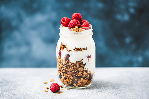 Granola with greek yogurt and raspberries in jar, healthy food, healthy eating concept
