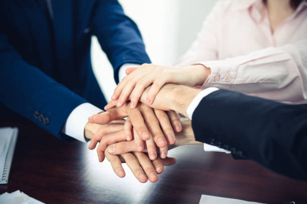 istock Business people group joining hands. Teamwork or meeting concepts 1145770484