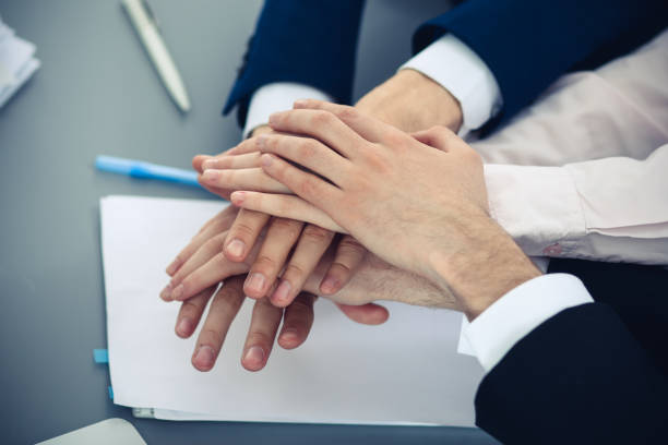 istock Business people group joining hands. Teamwork or meeting concepts 1145770530