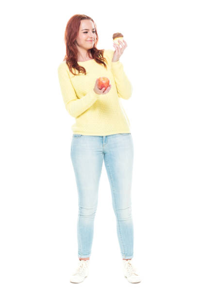 istock Female holding cupcake and apple 1145771794
