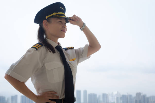 Proud female pilot at the airport. Side portrait of a young woman pilot looking proud of her accomplishments pilot training stock pictures, royalty-free photos & images