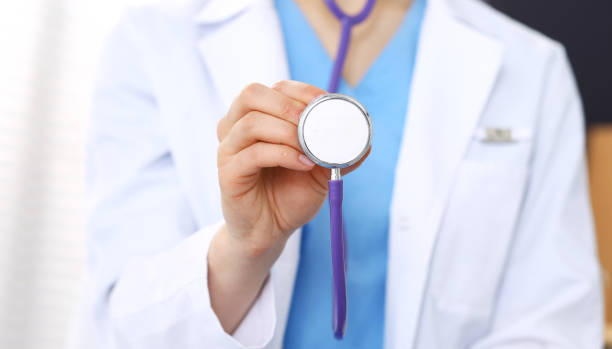 istock Unknown doctor woman holds stethoscope head, close-up. Physician ready to examine and help patient. Helping and insurance in health care, best treatment and medicine concept 1145772049