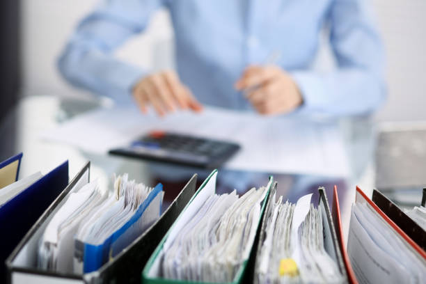 istock Unknown bookkeeper woman or financial inspector  making report, calculating or checking balance, close-up. Business portrait. Audit or tax concepts 1145772054