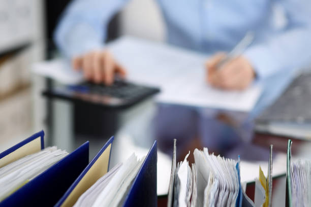 istock Unknown bookkeeper woman or financial inspector  making report, calculating or checking balance, close-up. Business portrait. Audit or tax concepts 1145772062