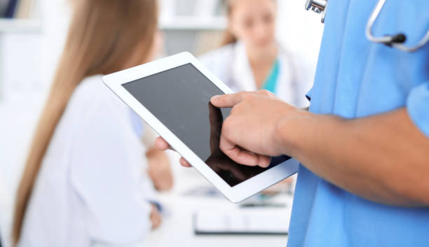 istock Surgeon doctor using tablet computer, close-up of hands at touch pad screen 1145772098