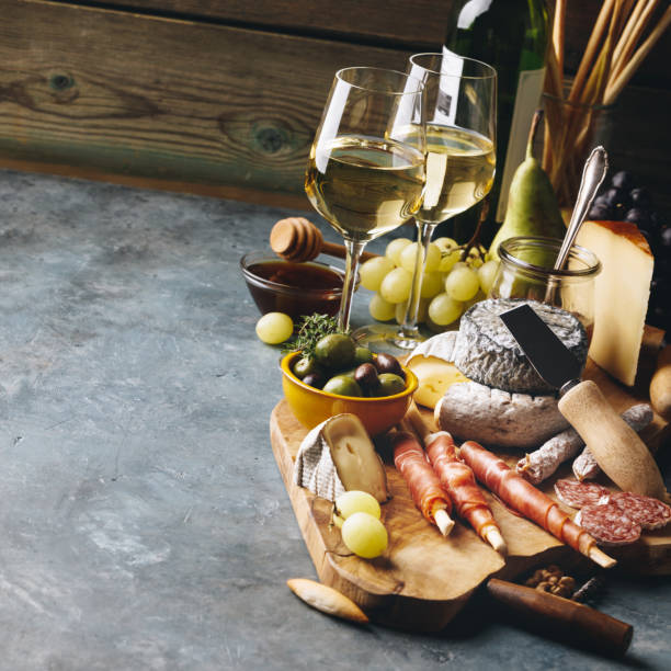 istock White wine with charcuterie assortment on the stone background 1145772263